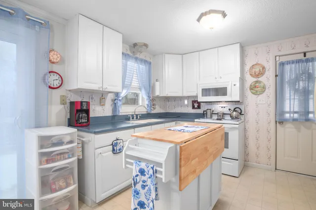 a kitchen with stainless steel appliances granite countertop a refrigerator sink and cabinets