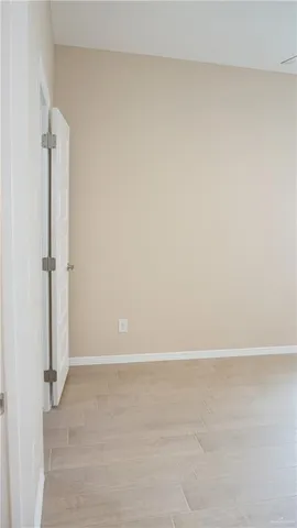 an empty room with a window and ceiling fan