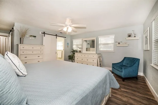 a spacious bedroom with a bed and window