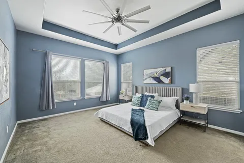 a spacious bedroom with a bed and a large window