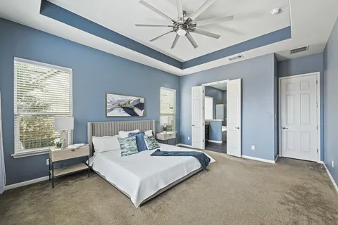 a bedroom with a large bed and a window