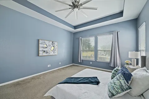 a bedroom with a bed and a chandelier