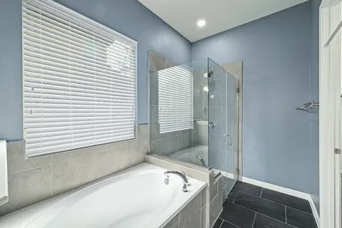 a bathroom with a bathtub and a shower