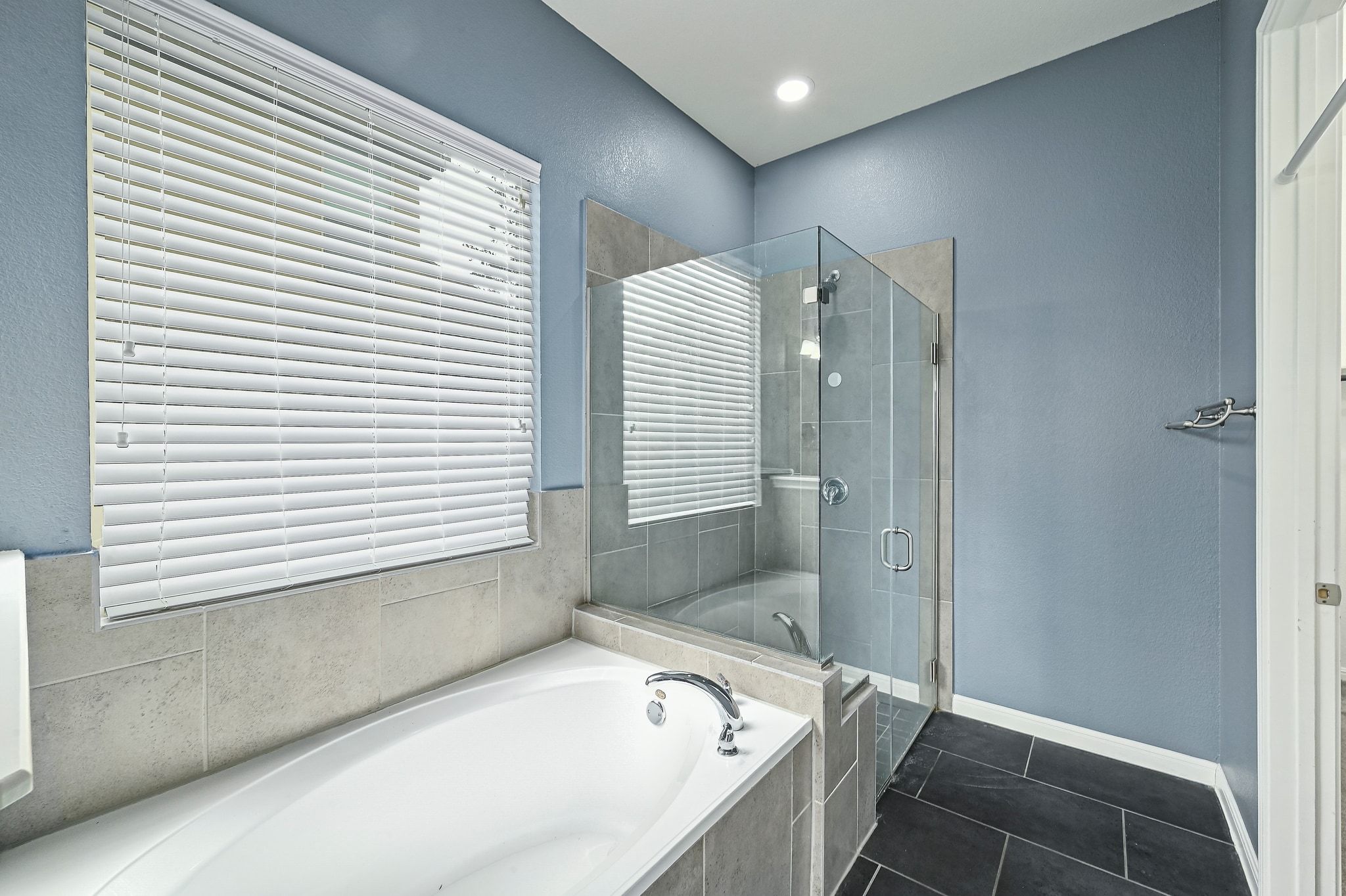 803 Wilson Ranch Place Cedar Park, TX 78613 - Photo 19 of 32 Enjoy a relaxing soaking tub and a separate walk-in shower enclosed by frameless glass.