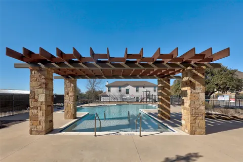 a view of a swimming pool with a patio