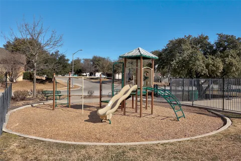 a view of a swimming pool with a yard and sitting area
