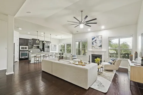 a living room with furniture fireplace and a large window