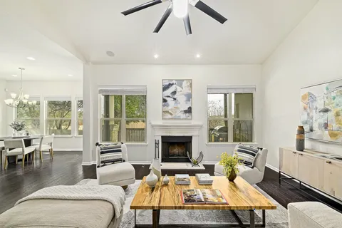 a living room with furniture fireplace and a large window
