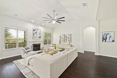 a living room with furniture fireplace and a large window