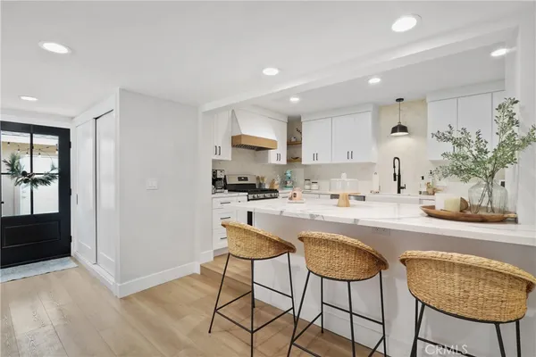 a kitchen with stainless steel appliances granite countertop a refrigerator and a stove top oven
