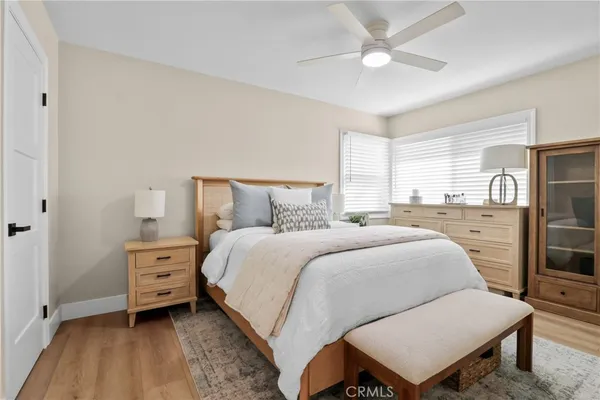 a bedroom with a bed and a night stand