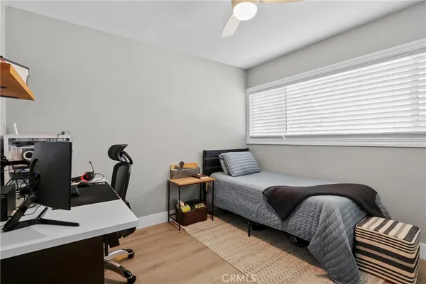 a bedroom with furniture and a window