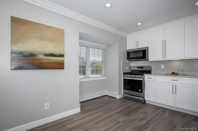 a kitchen with wooden floors and a stove