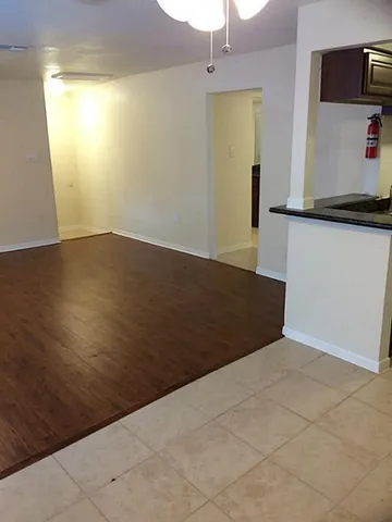 a view of a room with wooden floor and cabinet