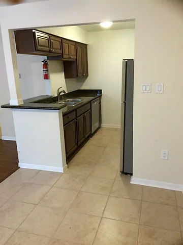 a kitchen with stainless steel appliances a refrigerator and a stove