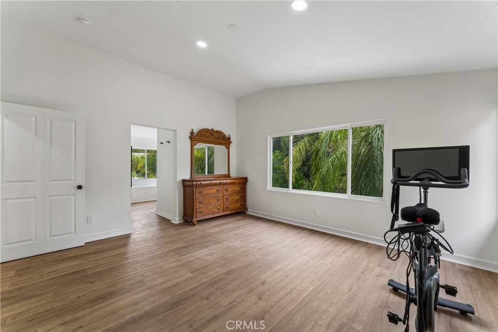 26023 Salinger Lane Stevenson Ranch, CA 91381 - Photo 15 of 35 Primary suite featuring vaulted ceilings and a large window with views of the backyard.