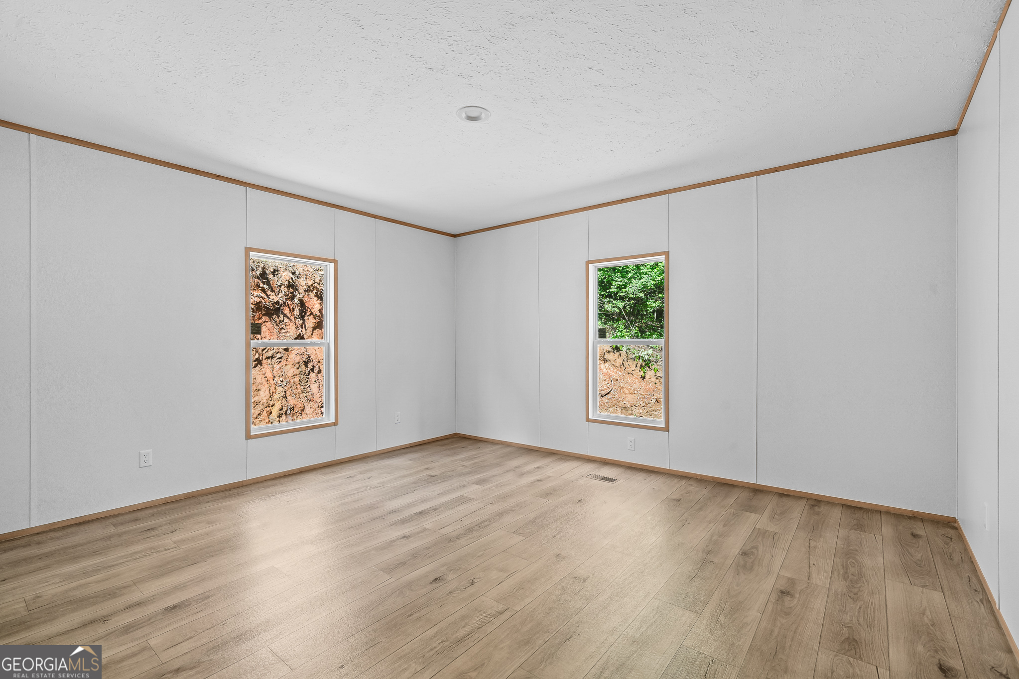 134 Double Line Road Ellijay, GA 30540 - Photo 25 of 33 a view of an empty room with window and wooden floor
