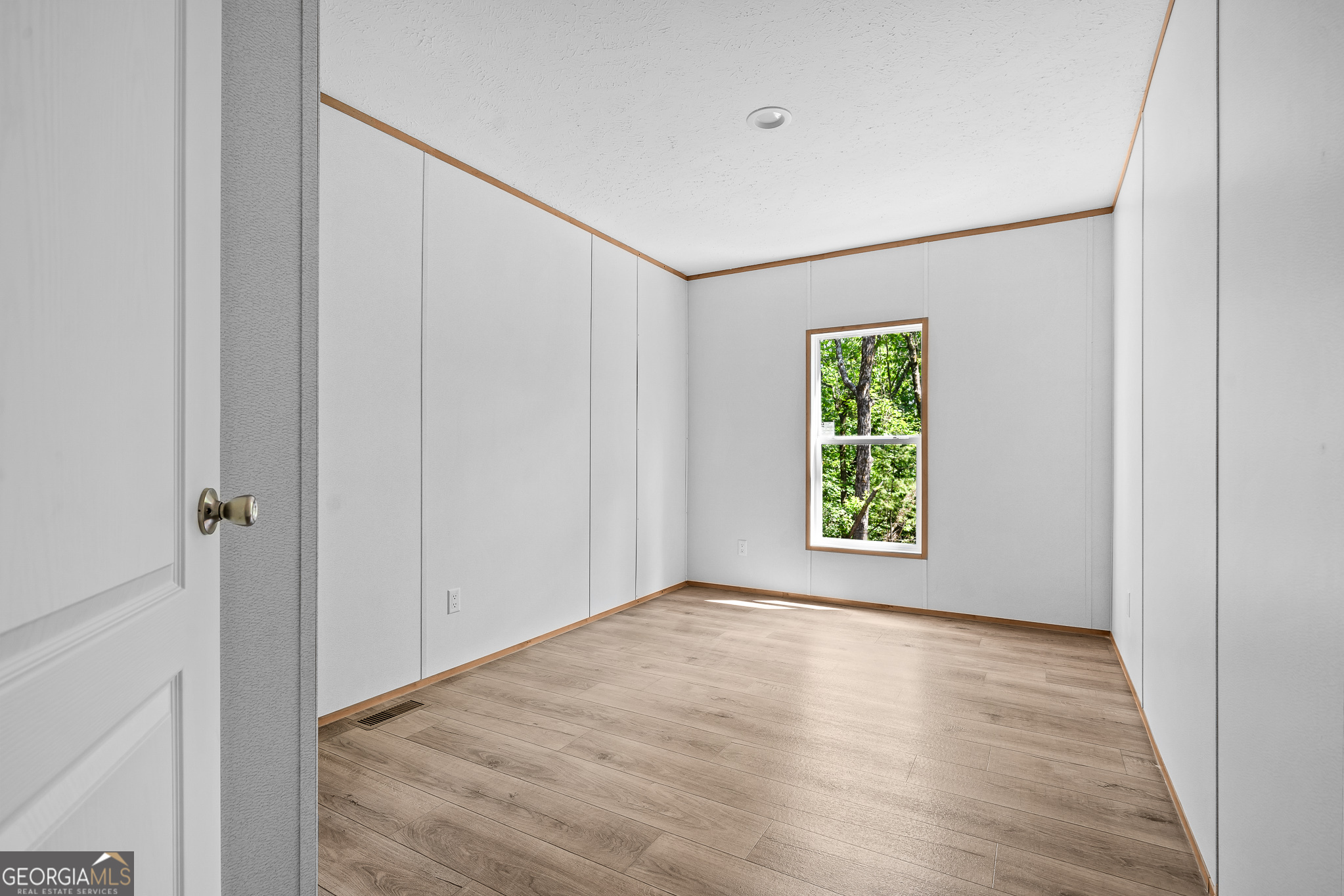 134 Double Line Road Ellijay, GA 30540 - Photo 32 of 33 a view of an empty room with wooden floor and a window