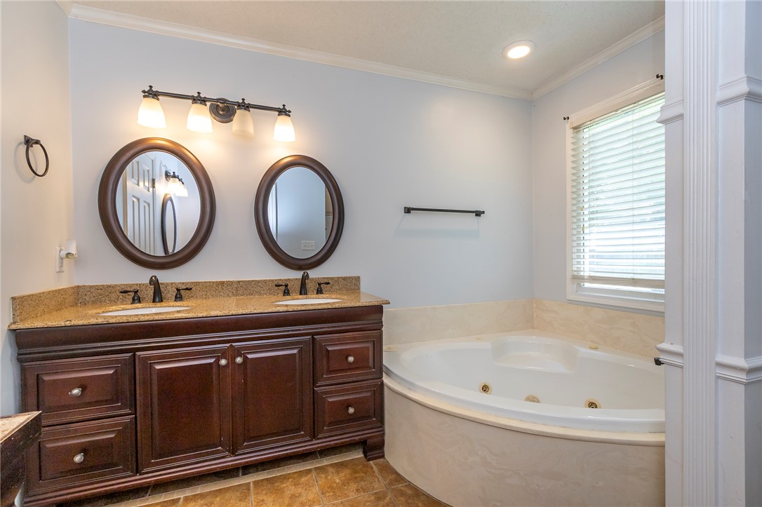 151 Hannah Circle Anderson, SC 29621 - Photo 17 of 46 This bathroom features a double vanity and soaking tub, offering a relaxing retreat.