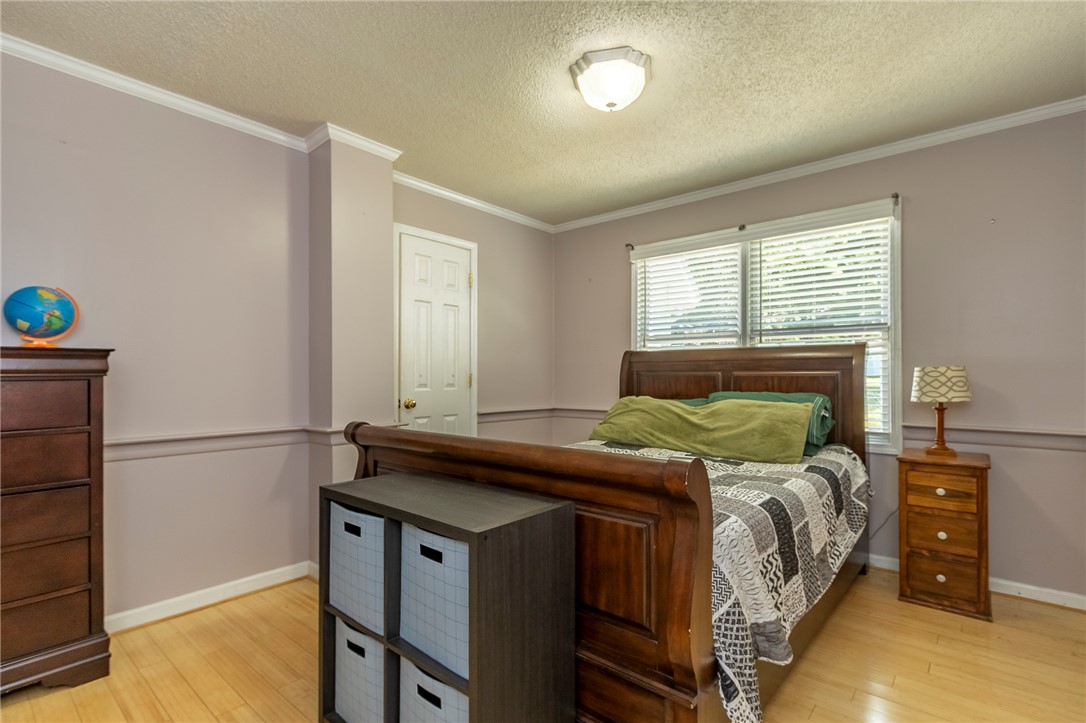 151 Hannah Circle Anderson, SC 29621 - Photo 19 of 46 This inviting bedroom features natural hardwood flooring and ample natural light from the window.