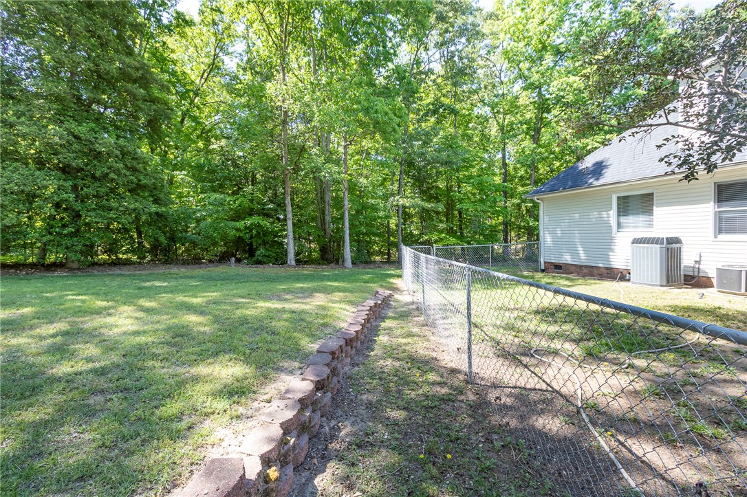 151 Hannah Circle Anderson, SC 29621 - Photo 39 of 46 This spacious yard features lush green grass and a tranquil wooded backdrop.
