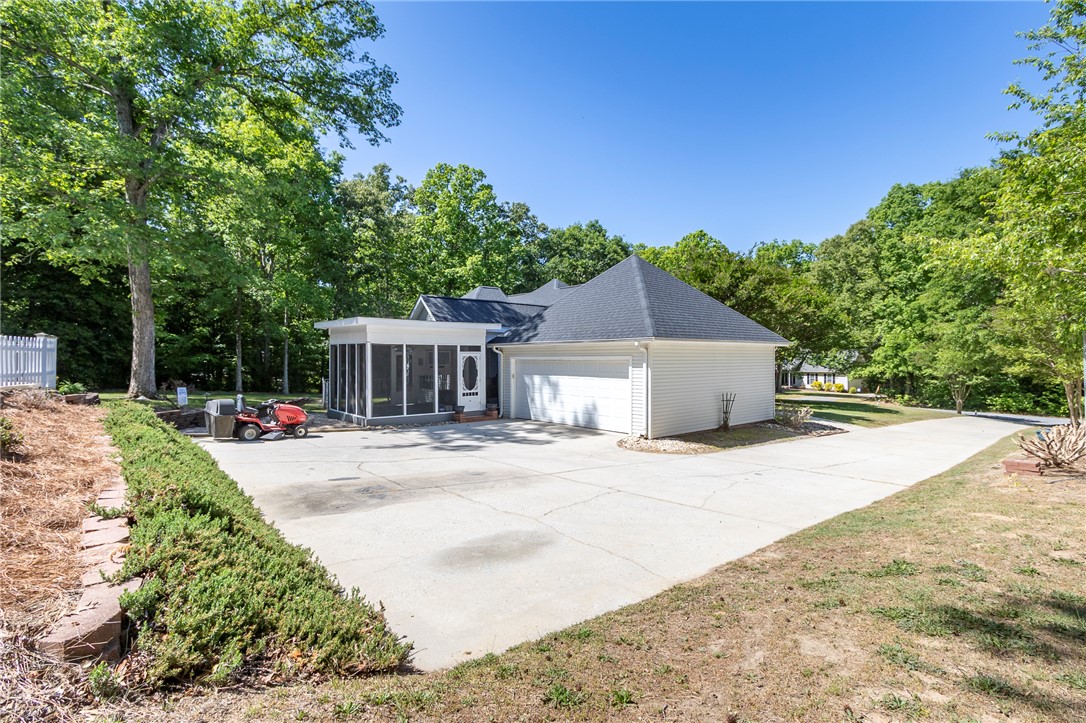 151 Hannah Circle Anderson, SC 29621 - Photo 43 of 46 This charming home offers a convenient attached garage and a welcoming screened porch, perfect for enjoying the outdoors.