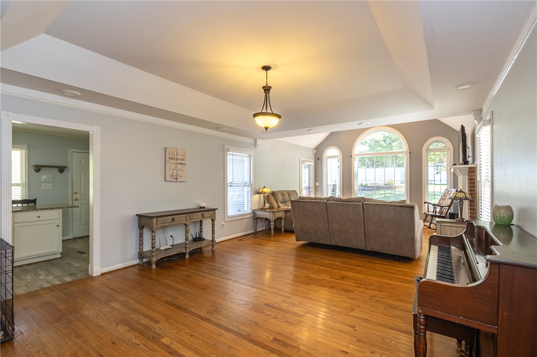151 Hannah Circle Anderson, SC 29621 - Photo 8 of 46 This inviting space features lustrous hardwood floors and architectural windows, offering natural light throughout the open layout.
