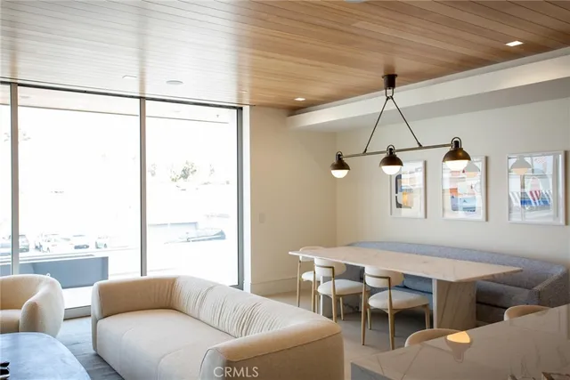 a living room with furniture a ceiling fan and a window