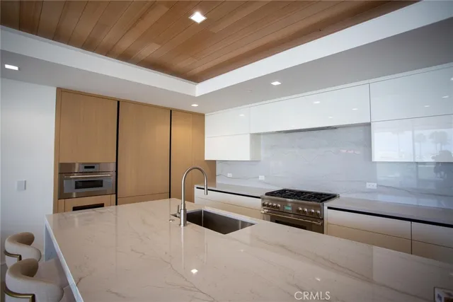 a kitchen with stainless steel appliances a sink a stove and a refrigerator