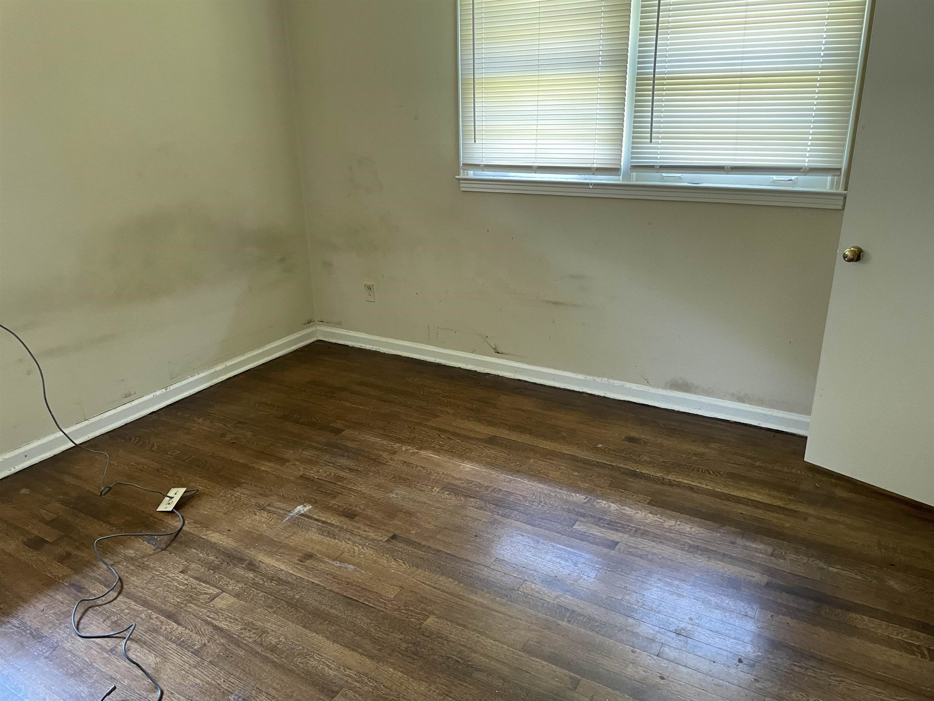 273 Clower Road Memphis, TN 38109 - Photo 11 of 13 an empty room with wooden floor and windows