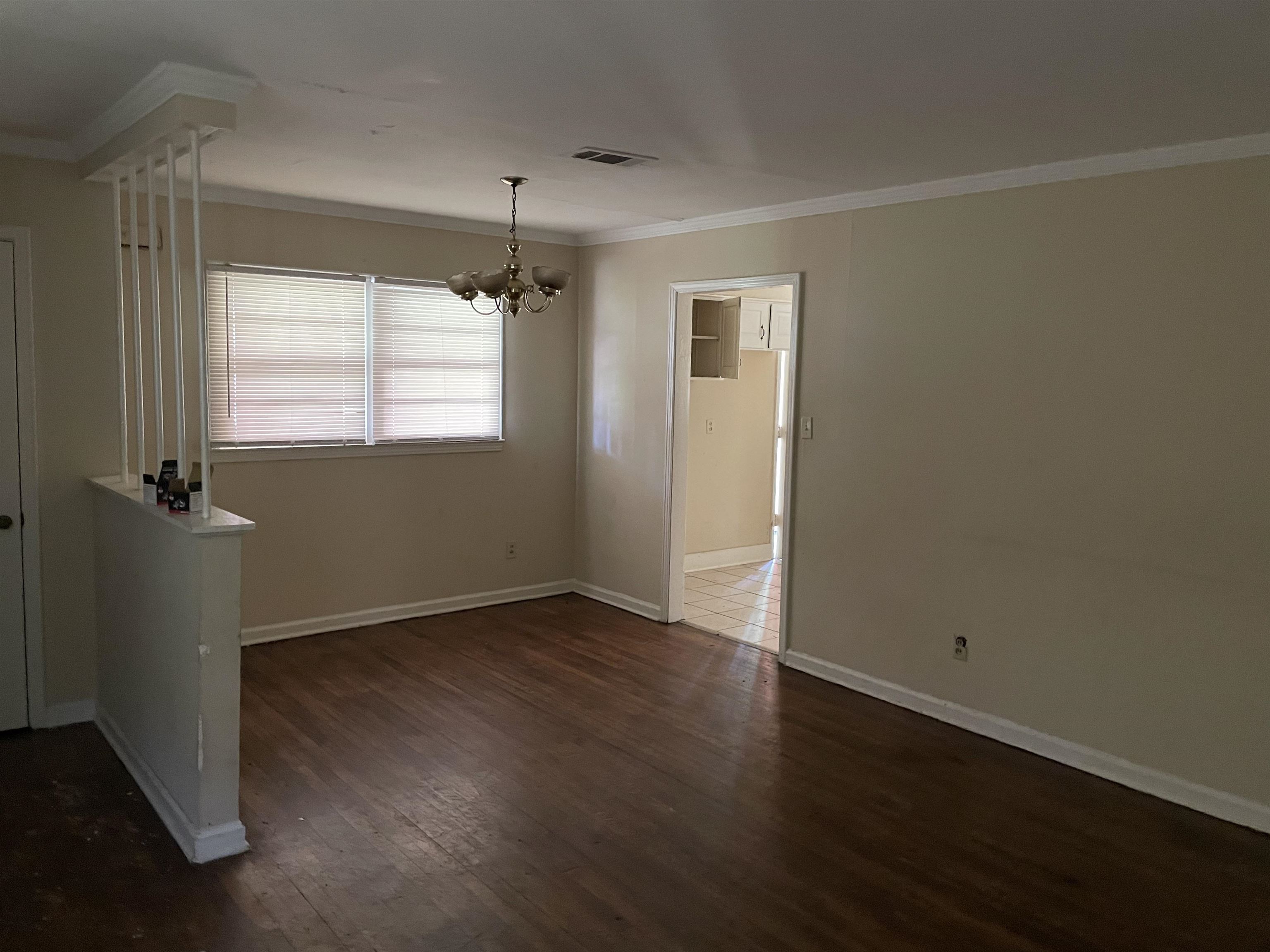 273 Clower Road Memphis, TN 38109 - Photo 4 of 13 an empty room with wooden floor and windows