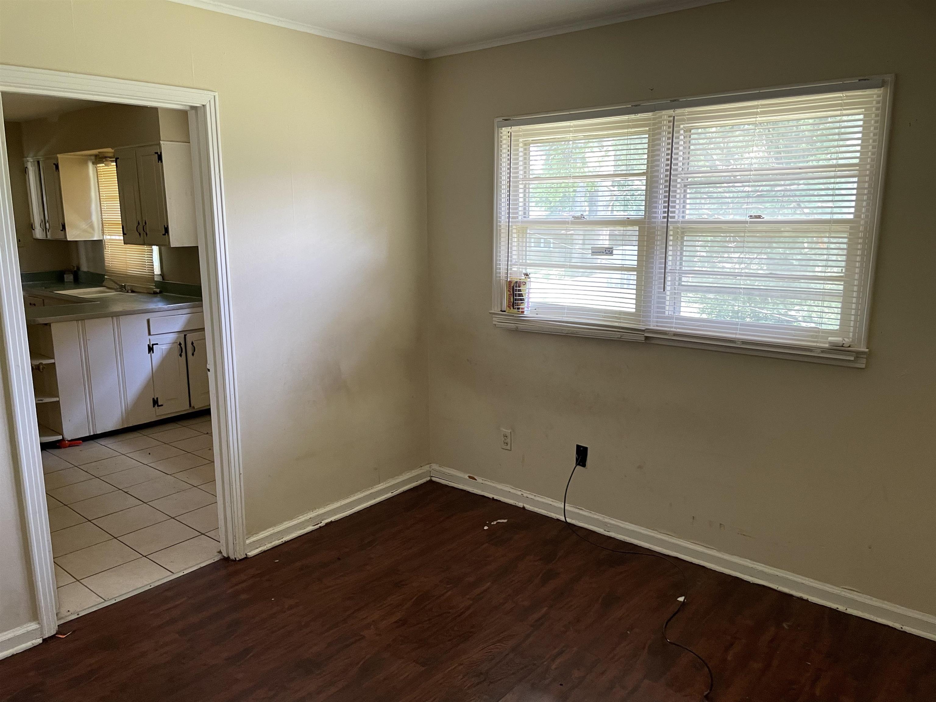 273 Clower Road Memphis, TN 38109 - Photo 8 of 13 a view of a room with wooden floor and a window