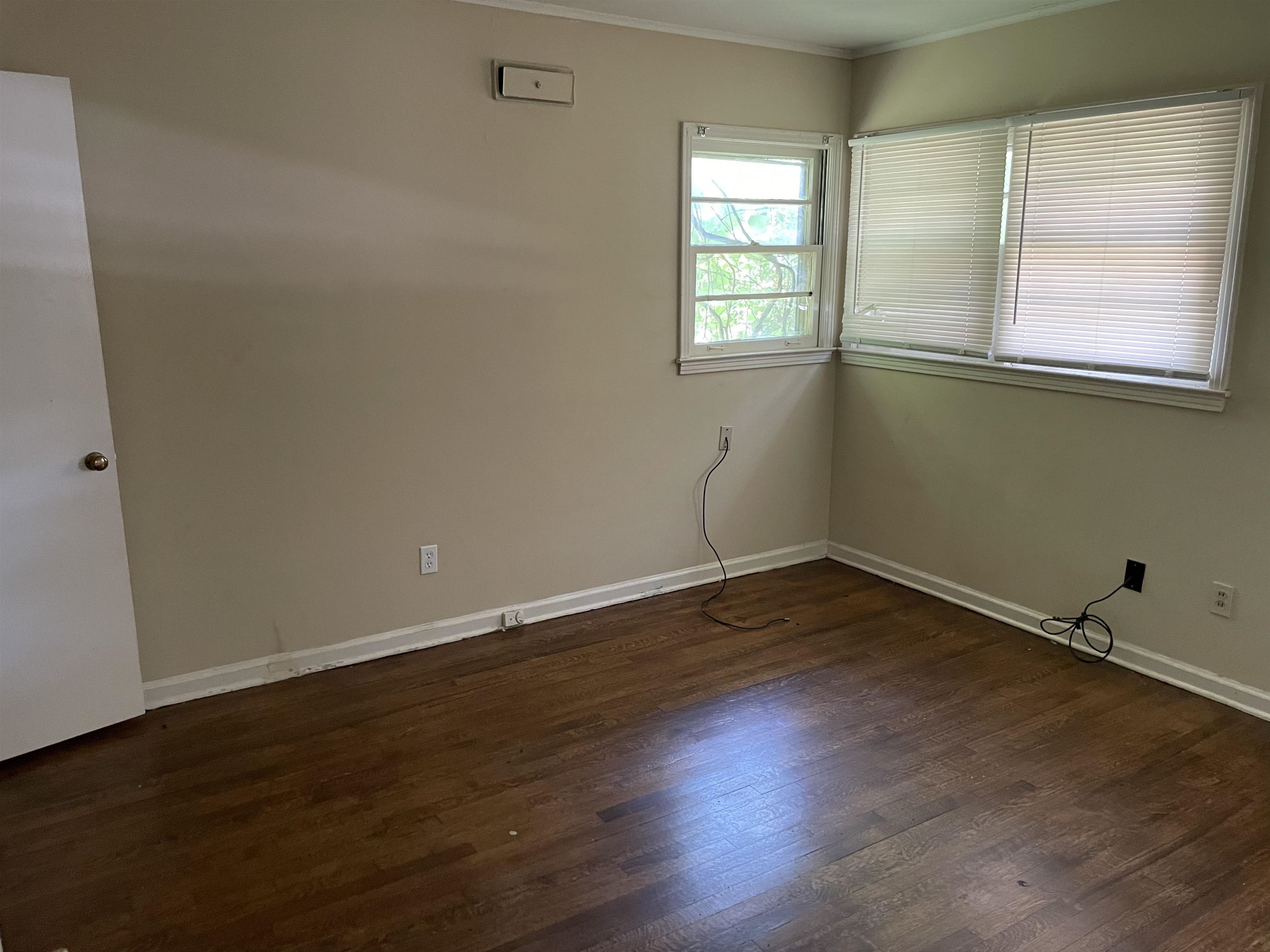 273 Clower Road Memphis, TN 38109 - Photo 9 of 13 an empty room with wooden floor and windows