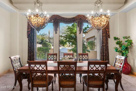 a kitchen with granite countertop cabinets and chair