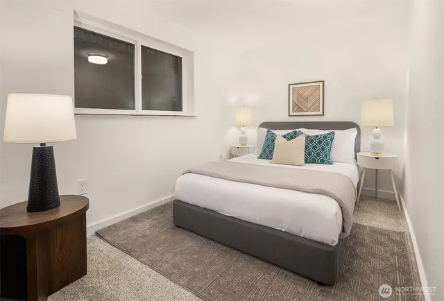 a bedroom with a bed and a lamp on table