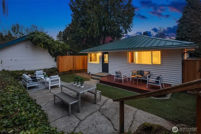 a view of backyard with outdoor seating a patio and plants