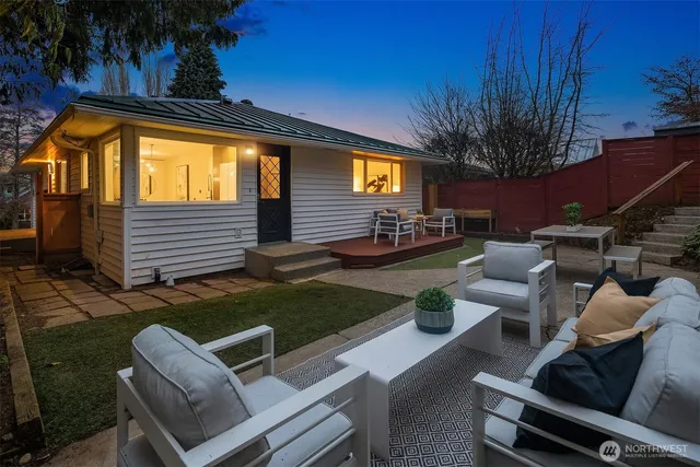 a view of backyard of house with seating space
