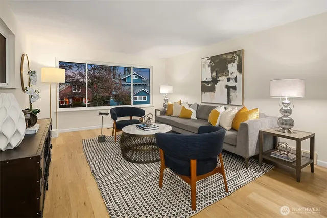 a living room with furniture a rug and a lamp