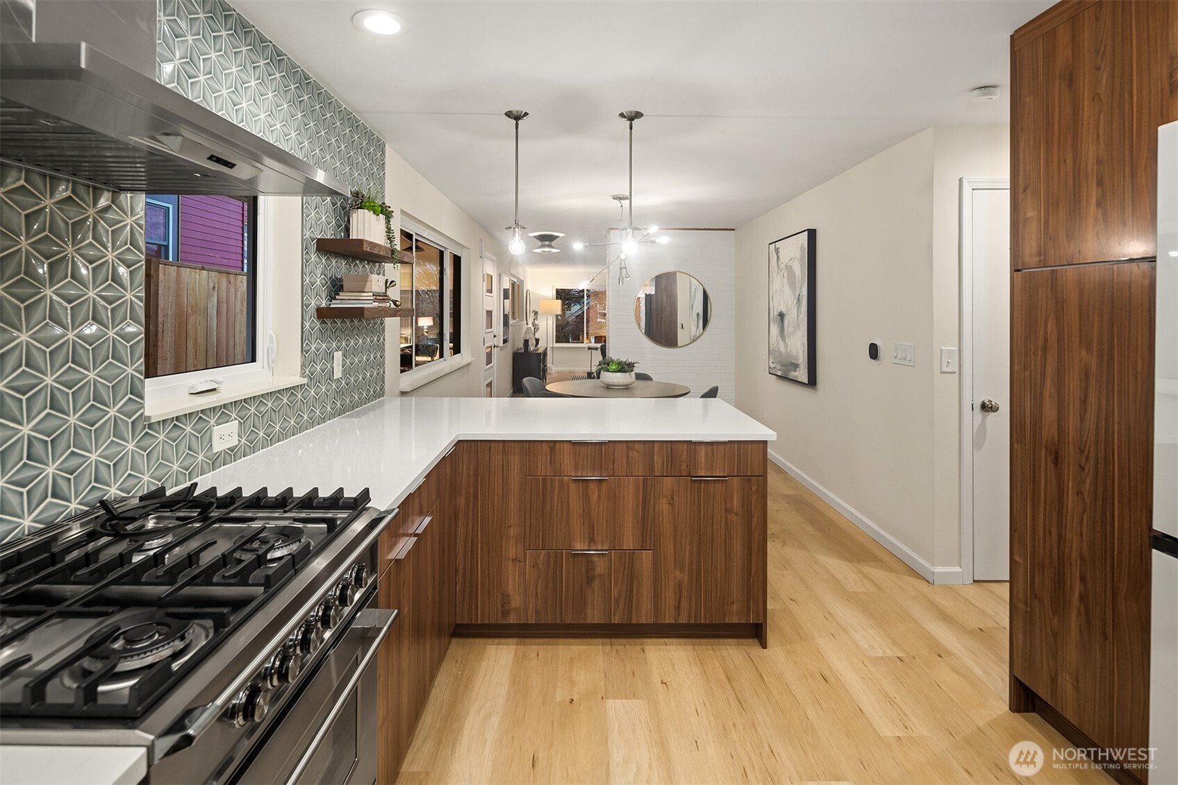 119 North 84th Street Seattle, WA 98103 - Photo 6 of 32 a kitchen with a stove a refrigerator and a wooden floor