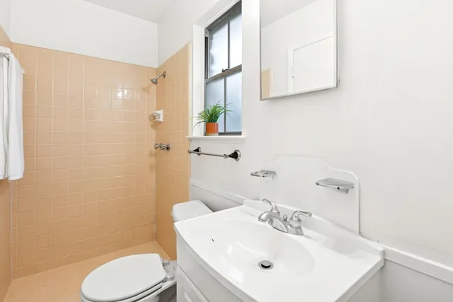 a bathroom with a sink a toilet and shower curtain