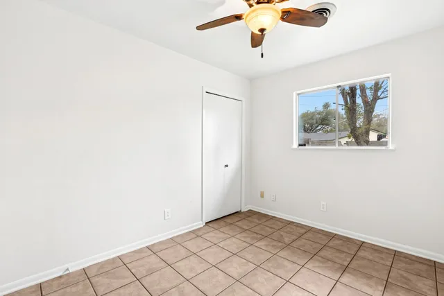 a view of a livingroom with a ceiling fan and window