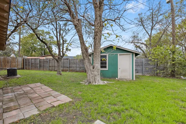 a white house that has a tree in front of it
