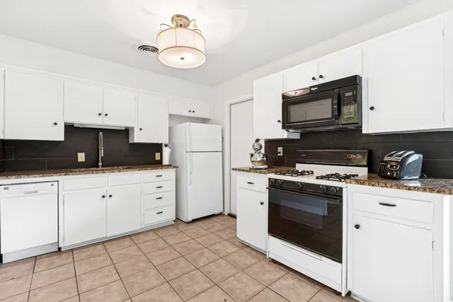 a kitchen with cabinets stainless steel appliances and a sink