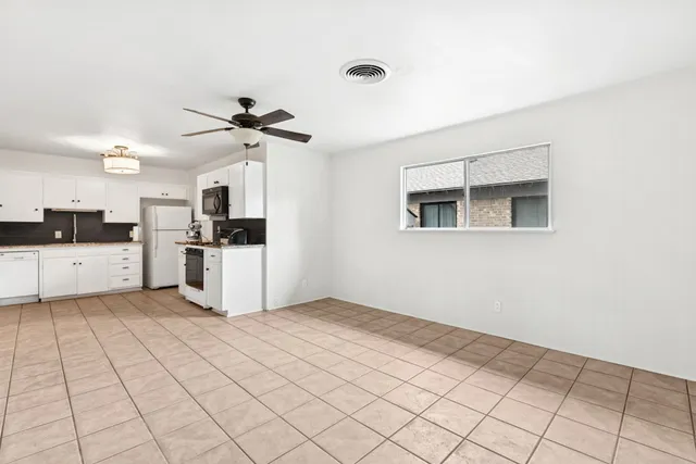 a view of a kitchen with a sink cabinets and entryway