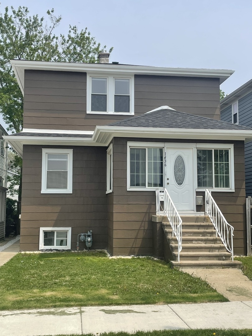 a front view of a house with a yard