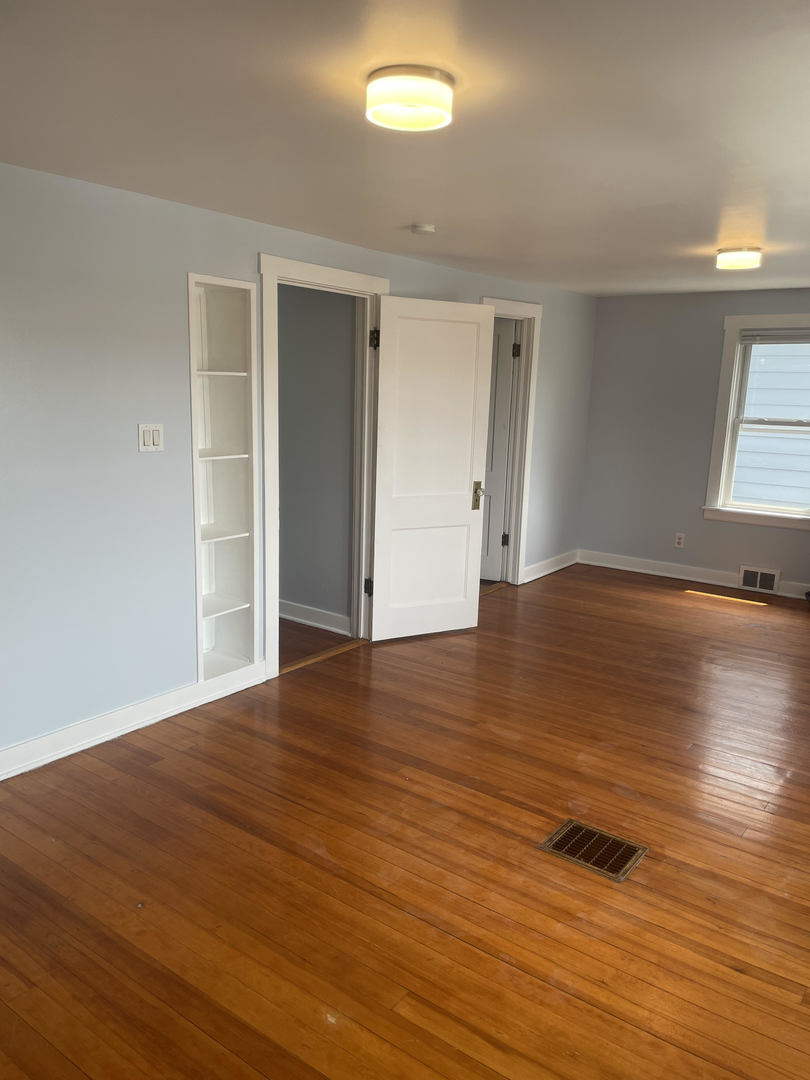 1436 Circle Avenue Forest Park, IL 60130 - Photo 11 of 18 a view of an empty room with wooden floor and a window