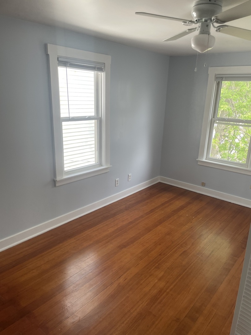 1436 Circle Avenue Forest Park, IL 60130 - Photo 13 of 18 an empty room with wooden floor windows and fan