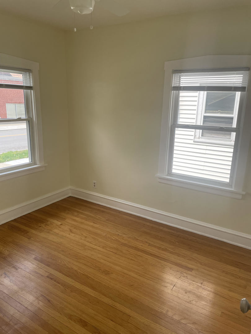 1436 Circle Avenue Forest Park, IL 60130 - Photo 16 of 18 a view of an empty room with wooden floor and a window