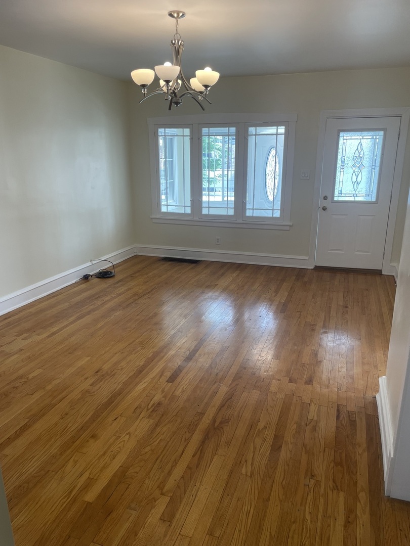 1436 Circle Avenue Forest Park, IL 60130 - Photo 3 of 18 an empty room with wooden floor and windows