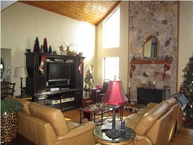 1054 Melton Road Baker, FL 32531 - Photo 18 of 34 a living room with furniture a flat screen tv and a fireplace